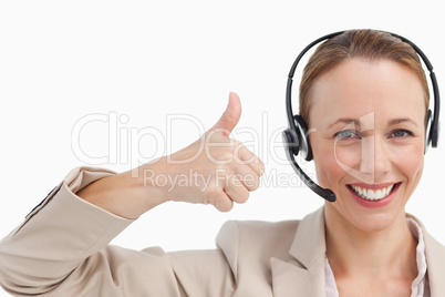 Woman in a suit with a headset the thumb-up