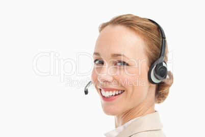 Portrait of a smiling woman in a suit with headset