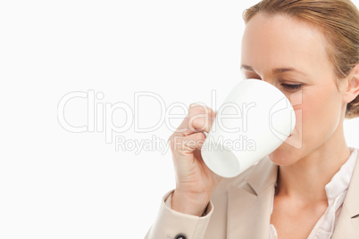 Woman in a suit drinking a coffee