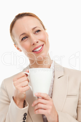 Redhead woman in a suit holding a mug