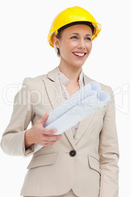 Smiling woman in a suit wearing a safety helmet