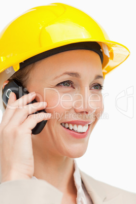 Close-up of a woman wearing safety helmet on the phone