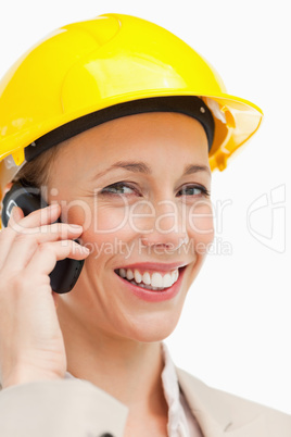 Portrait of a woman on the phone wearing safety helmet