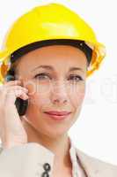 Portrait of a businesswoman on the phone wearing safety helmet