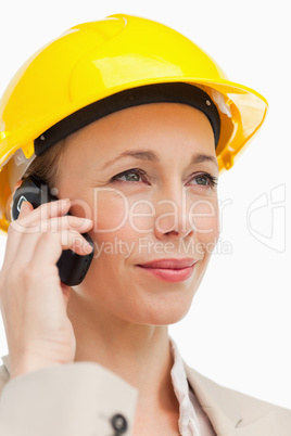 Woman on the phone wearing safety helmet