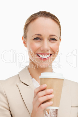 Portrait of a woman in a suit holding a takeaway coffee