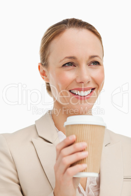 Woman in a suit holding a takeaway coffee
