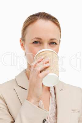 Portrait of a woman in a suit drinking a takeaway coffee