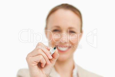 Smiling businesswoman writing on a board