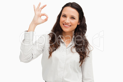 Portrait of a brunette approving with hand