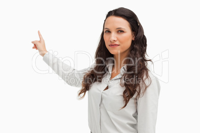 Portrait of a brunette pointing in her back