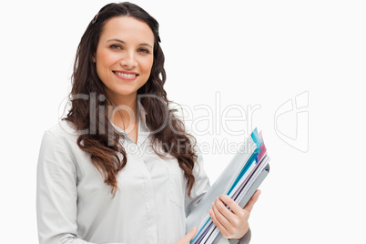 Portrait of brunette holding files