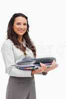 Portrait of a brunette carrying a lot of files