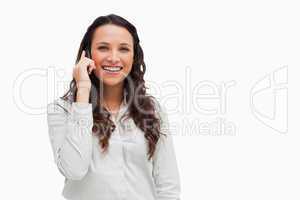 Close-up of a brunette grimacing while phoning