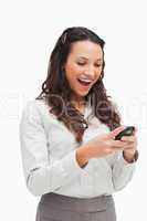 Happy brunette looking her text message