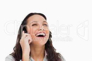 Brunette laughing while making a call