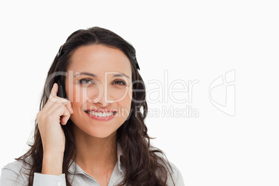 Portrait of a smiling brunette making a call