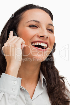 Close-up of a brunette beaming while calling