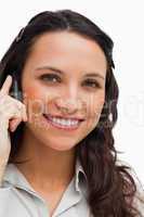 Portrait of a brunette smiling while calling