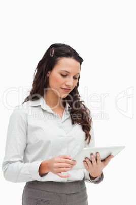 Brunette standing while using a touchpad