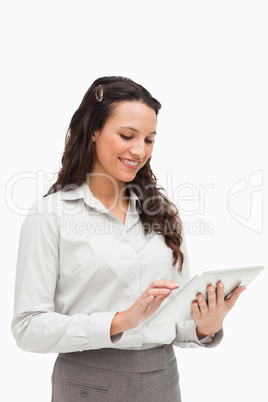 Brunette standing while using a touch pad