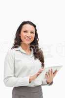 Portrait of a brunette standing while using a touchpad