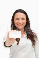 Brunette showing a card