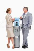 Business people talking next to the water dispenser