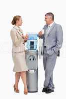 Business people laughing next to the water dispenser