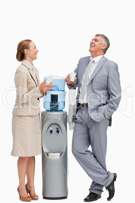 People laughing next to the water dispenser