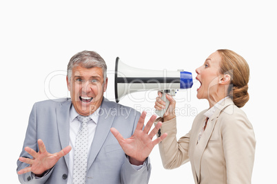 Businesswoman using a megaphone after her colleague