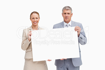 Business people holding a poster