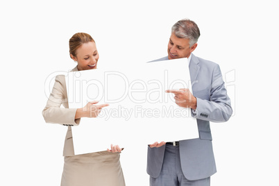 Business people holding and pointing a poster
