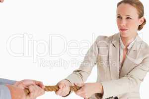 Businesswoman pulling the rope