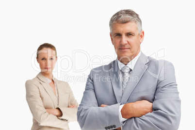 Two business people with folded arms