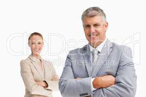 Smiling business people with folded arms