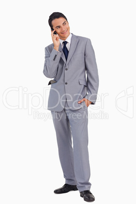 Man in a suit smiling while calling