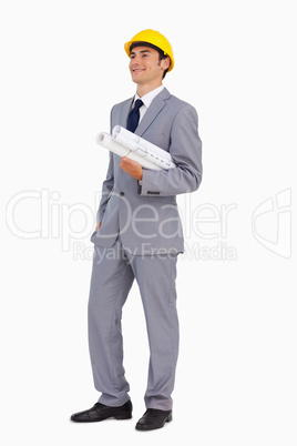 Smiling man in a suit with safety helmet and plans