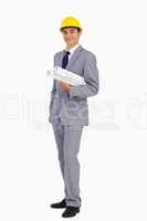 Man in a suit with safety helmet and plans