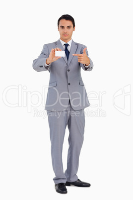 Good-looking man showing and pointing his business card