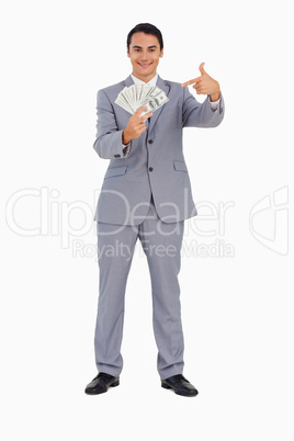 Portrait of a good-looking man showing a lot of dollars