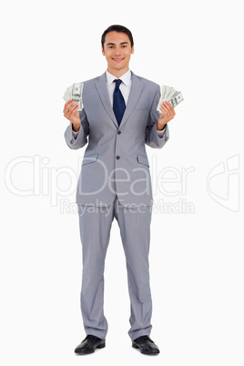 Portrait of a good-looking man with a lot of dollars