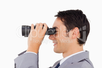 Close-up of a businessman using binoculars