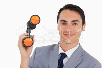 Close-up of a smiling businessman with binoculars