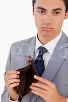 Portrait of a man in a suit with an empty wallet