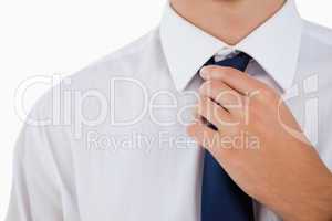 Close-up of a man doing his tie