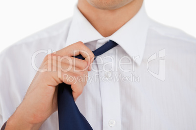 Close-up of a man undoing his tie