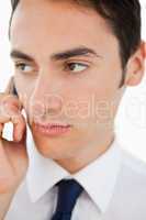 Close-up of a man in a suit calling with his cellphone