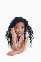 A front view shot of a surprised young girl talking on her mobil