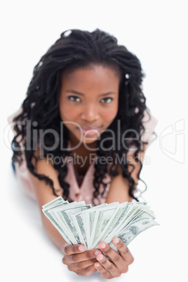 A young woman is holding American dollars in her hands